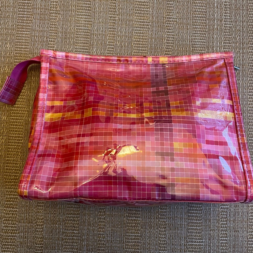 Clinique pink, purple, yellow cosmetic case zip close